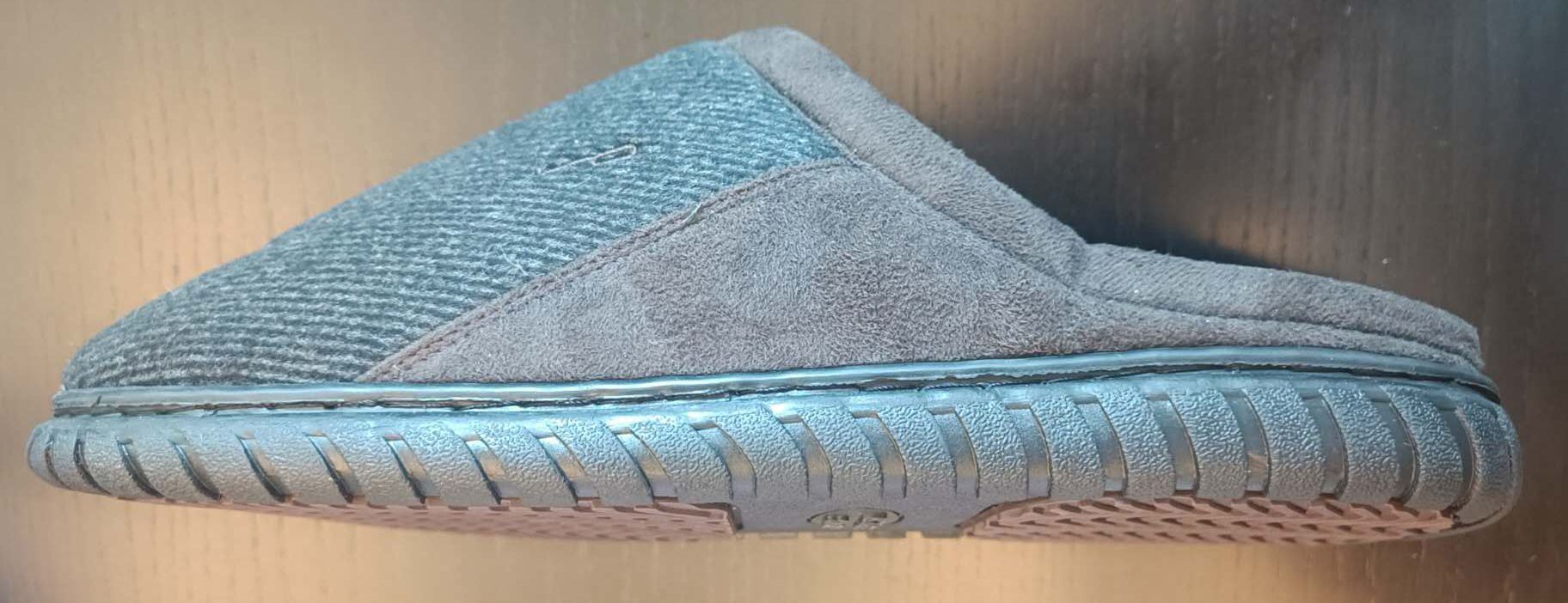 Ciabatta con tomaia in materiale tessile la cui suola è costituita da materiale tessile integrato con materiale polimerico in modo tale che i singoli costituenti non possano essere separati. La superficie della suola è costituita da una base di colore nero (che costituisce anche la bordatura della pantofola) su cui sono incollate altre due suola di colore marrone con rilievi antiscivolo che vanno a contatto con il terreno. L’intersuola è costituita da materiale polimerico, non è removibile ed è foderata dalla parte a contatto con il piede, con materiale tessile.