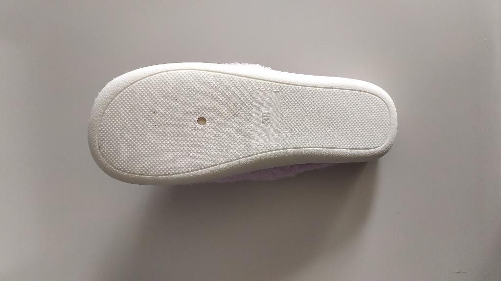Pantofola con tomaia in materiale tessile effetto peluche, di colore lilla e decorazione con disegno centrale.
La suola è composta da materiale tessile supportato da uno strato di gomma in cui è integrato in modo da non poter essere staccato.
L’intersuola è costituita da materiale polimerico, non è removibile ed è foderata dalla parte a contatto con il piede, con materiale tessile. Suola esterna in materiale tessile.