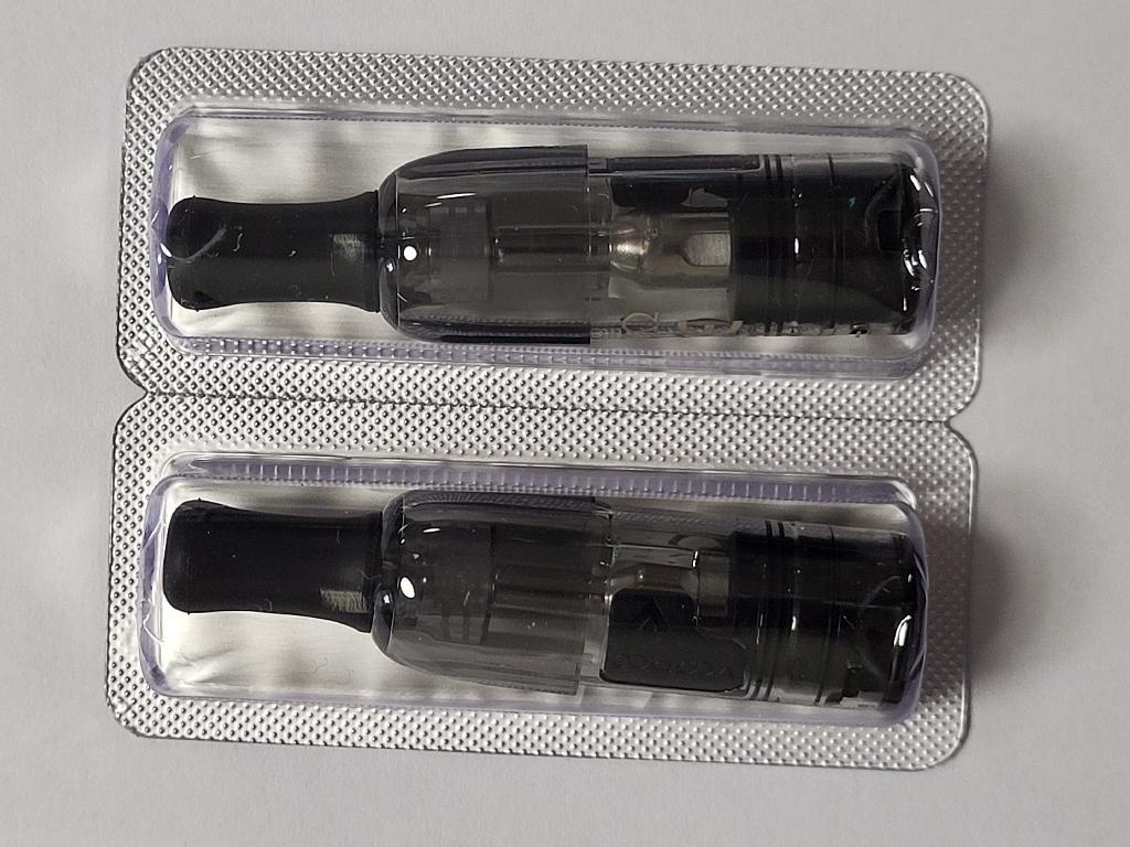 Elektroninės cigaretės kapsulė (POD).
Kapsulę sudaro kandiklis ir plastikinė talpykla su integruotu kaitinimo elementu. Ji skirta e. skysčiui laikyti ir garinti. Kapsulė turi specialias jungtis, leidžiančias ją prijungti prie elektroninės cigaretės maitinimo įrenginio, kuris tiekia energiją kaitinimo procesui.
Kapsulė pateikiama be elektroninių cigarečių skysčio.
Gaminiai supakuoti mažmeninei prekybai skirtose pakuotėse.