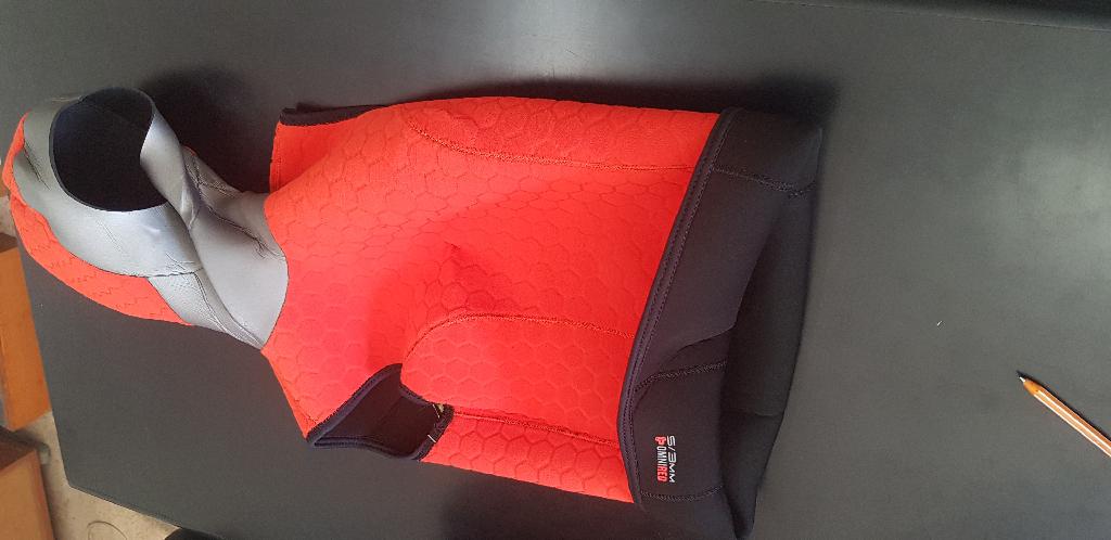 As per sample and description provided -  Ultrawarmth hooded vest without arms.  It is made of neoprene and covered on both sides with textile material.
Hooded vest is used by divers