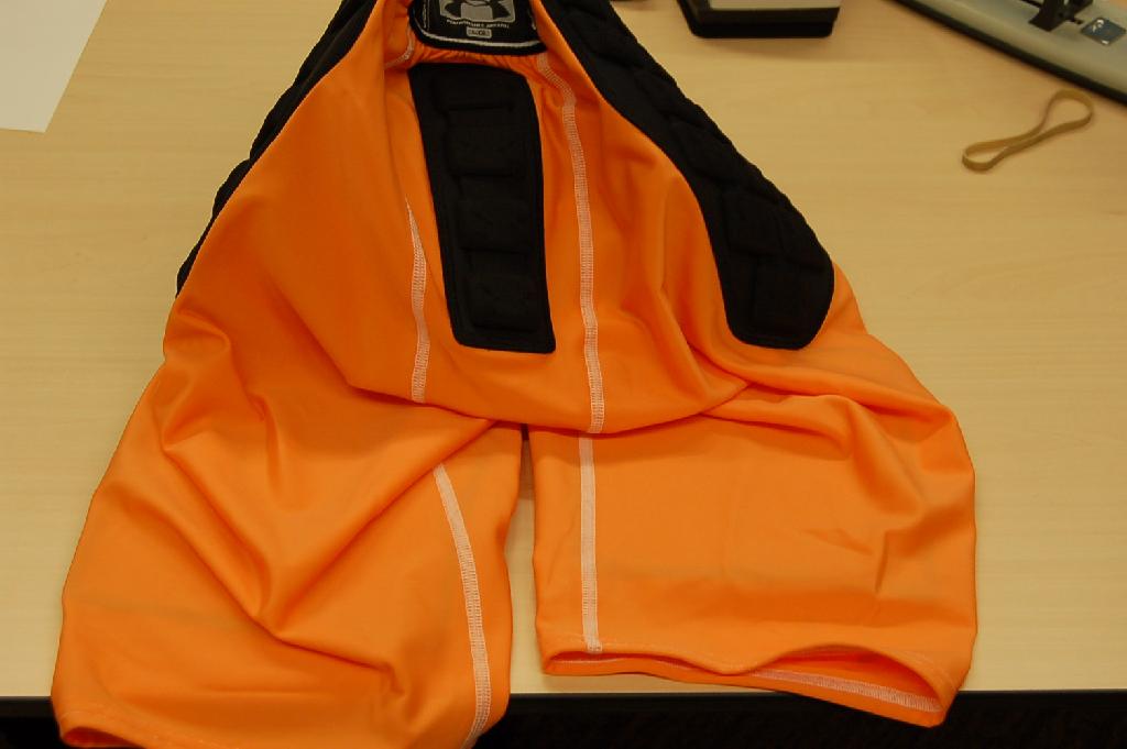 Een korte broek voor heren van breiwerk (88% polyester en 12% elasthan) met ondermeer de volgende kenmerken:
- reikend tot boven de knie, aan de bovenzijde nauwsluitend door middel van twee elastische banden, één aan de voorzijde en één aan de achterzijde;
- zonder zakken;
- aan de voorzijde van de broekspijpen zijn twee beschermstukken opgestikt;
- ter hoogte van de heupen is een driehoekig beschermstuk opgestikt;
- aan de achterzijde is een beschermstuk voor het staartbeen opgestikt;
- aan de voorzijde, in het kruis, is het breiwerk vervangen door een ander soort breiwerk;
- aan de binnenzijde van de dit breiwerk is een vak aangebracht waarin een zogenaamde tok (beschermplaat) kan worden geschoven;
- de bovenzijde en de broekspijpen zijn omgezoomd;
- op de rechter broekspijp is een logo aangebracht.
De broek wordt onder andere gebruikt als beschermingskleding bij het "American football".
