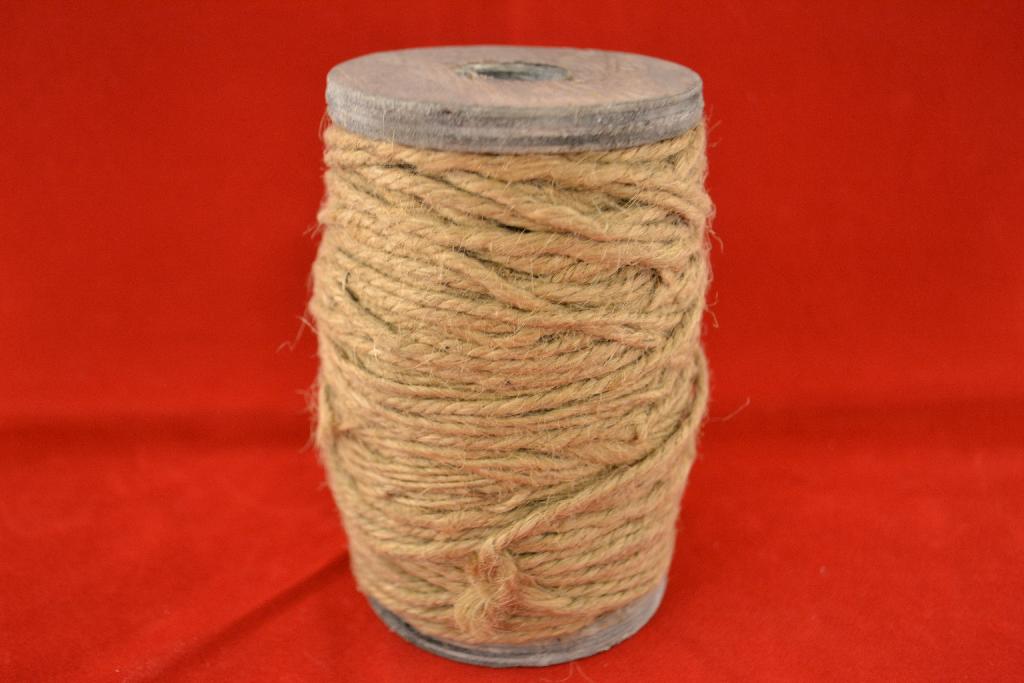 Een klos met touw met onder meer de volgende kenmerken:
- het touw is –volgens opgave- vervaardigd van jute;
- het touw is gemaakt van 3 strengen;
- de klos is vervaardigd van hout;
- de klos is voorzien van een merknaam en een logo;
- afmetingen van ongeveer 12 x 8 cm.