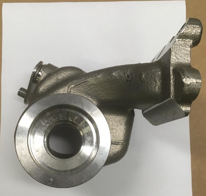 Korpus turbiny turbosprężarki, w kształcie nieregularnego odlewu o wymiarach około 165x145x131 mm. Korpus składa się z obszaru wlotu i wylotu spalin, woluty oraz wirnika turbiny o średnicy 31 mm. Korpus wykonany jest ze stali żaroodpornej na bazie chromu i niklu, odpornej na działanie wysokich temperatur - maksymalna temperatura pracy materiału wynosi 1000 stopni C. Ponadto w skład korpusu wchodzą: zawór wahadłowy – 1 szt. (materiał: stal żaroodporna), wałek regulacyjny – 1 szt. (materiał: stal żaroodporna), podkładka – 1 szt. (materiał: stal żarowytrzymała), sprężyna talerzowa - 2 szt. (materiał: stal żarowytrzymała), kołek ustalający – 1 szt. (materiał: stal nierdzewna), tuleja –  1szt. (materiał: stal żaroodporna), sworzeń – 2 szt. (materiał: stal nierdzewna), dźwignia regulacyjna – 1 szt. (materiał: stal nierdzewna). Zadaniem korpusu jest kierowanie gazów wydechowych z silnika spalinowego na wirnik turbiny, a następnie orientowanie tych gazów do układu wydechowego w pojeździe. Korpus pełni również funkcję ochronną przed czynnikami zewnętrznymi. Celem kołka ustalającego jest prawidłowe spozycjonowanie korpusu turbiny w zespole turbosprężarki.