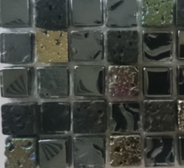 Mozaika wykonana z kostek szklanych i kamiennych (lawa wulkaniczna), o wymiarach 14 mm x 14 mm x 8 mm. Ilość kostek szklanych i kamiennych jest losowa. Największą powierzchnie stanowią kostki szklane (ok. 84%) o zaoblonych krawędziach. Powierzchnia dekoracyjna części kostek kamiennych jest malowana farbami, a część poddana procesowi galwanizacji. Tak przygotowane kostki umieszczone są na podłożu -  siatce z tworzywa  sztucznego - za pomocą kleju żywicznego, tworząc tafle o  wymiarach  30 mm x 300 mmm (± 5 mm) , o grubość 8 mm. Mozaiki są stosowane jako materiał do wykładania ścian wewnątrz pomieszczeń. Prezentowane po 11 szt. w opakowaniu zbiorczym. Decyzja wydana w miejsce decyzji nr PL BTI WIT-2021-000964.