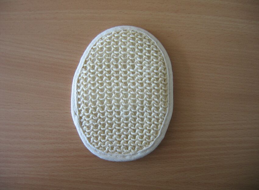 Myjka do masażu o wymiarach 15 x 10 cm w kształcie owalu. Artykuł składa się z cienkiej gąbki z tworzywa sztucznego pokrytej z jednej strony dzianym sizalem, a z drugiej strony dzianą tkaniną frotową. Posiada gumowy pasek dł. ok. 9,5 cm do nałożenia na rękę. Artykuł przeznaczony do codziennej pielęgnacji ciała. Opakowanie stanowi torebka z tworzywa sztucznego.